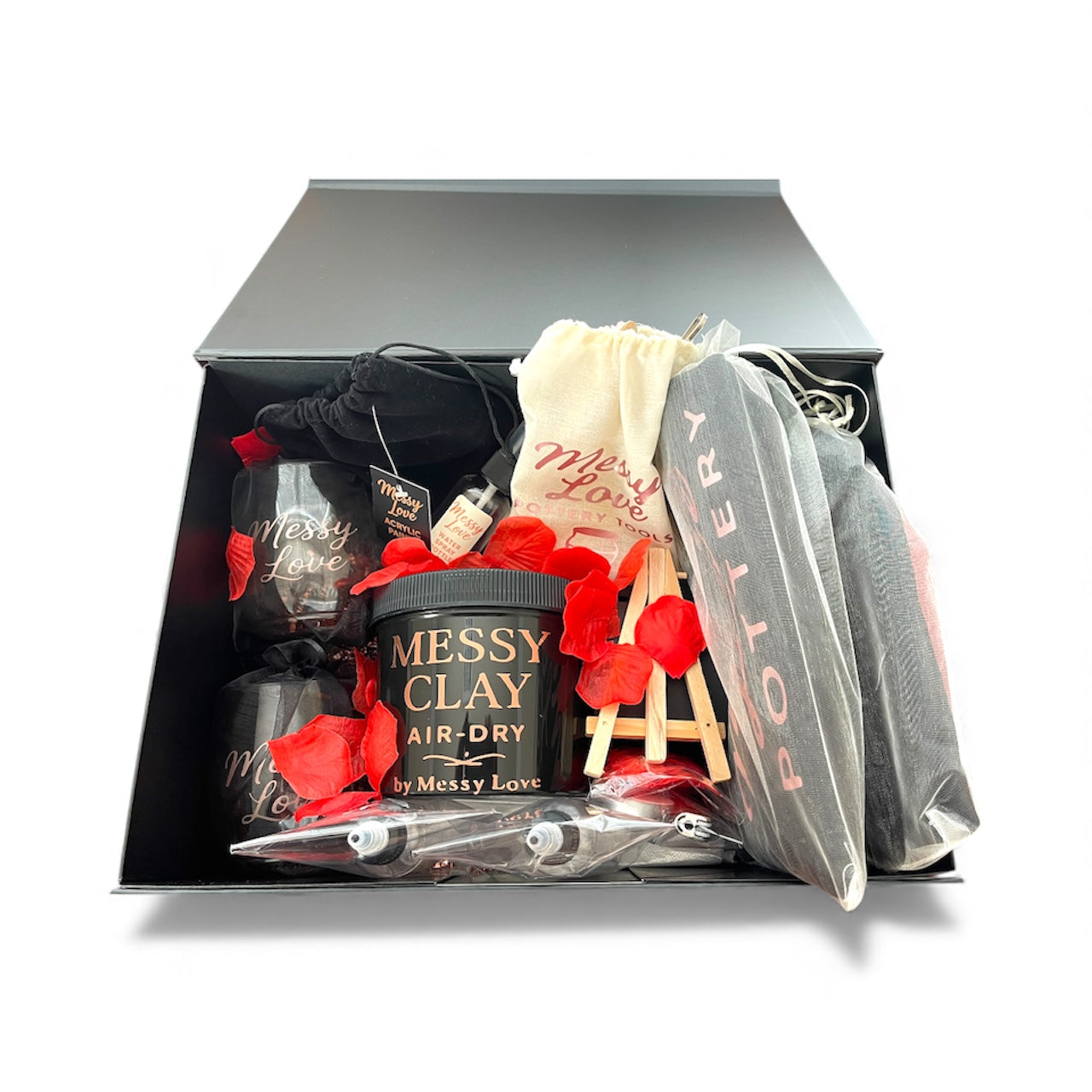 Gift set with 'Messy Clay' air-dry clay and pottery tools in a black box.